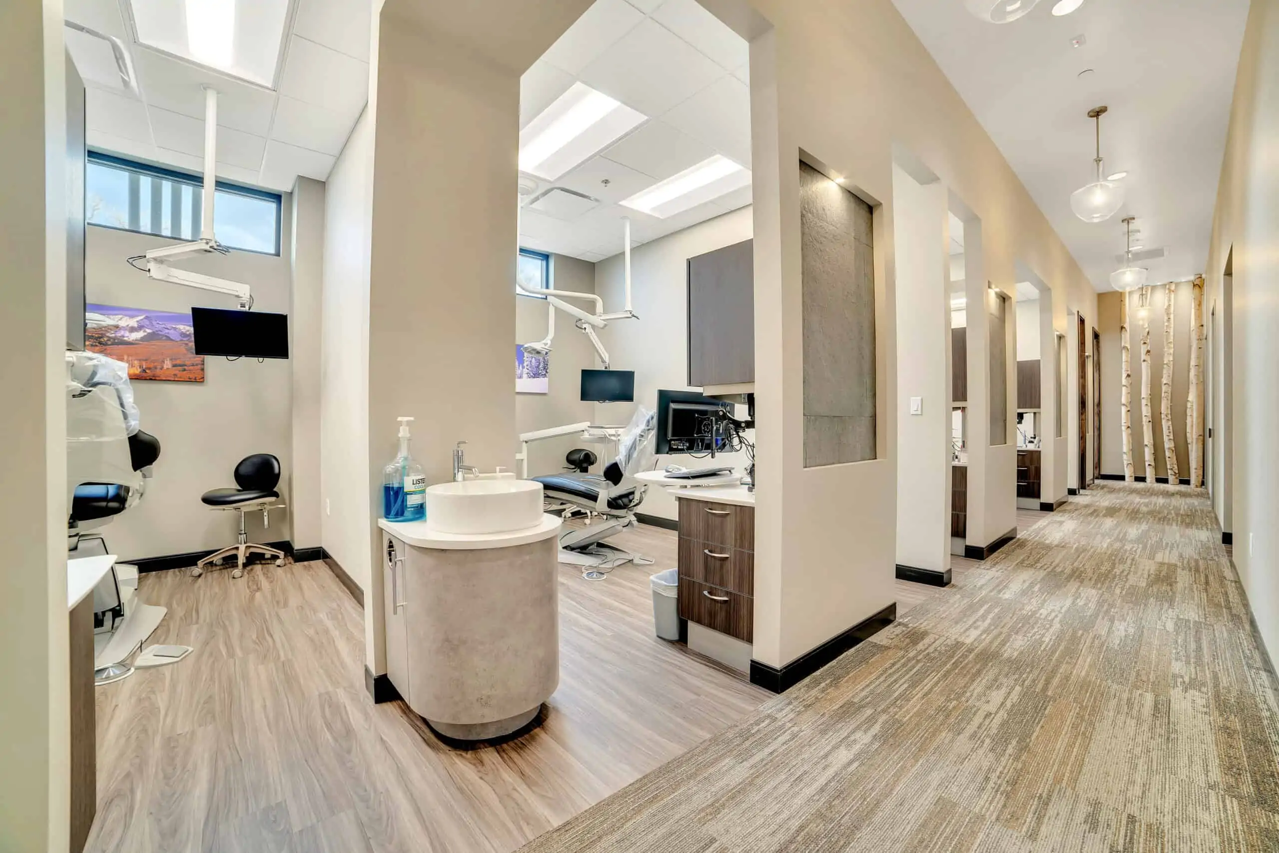 A hallway at Signature Dentistry of Arvada leading to several comfortable-looking dental offices