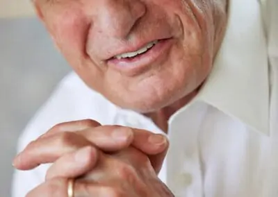 Patient smiling with straight, even, white teeth after receiving treatment at Signature Dentistry of Arvada