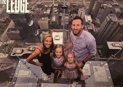 Dr. Woods with his family posing in front of skyscrapers